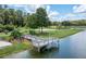 Wooden deck overlooking a lake with playground nearby at 1017 Park Ridge Cir, Kissimmee, FL 34746