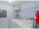 Laundry room with washer, dryer and shelving for storage at 1017 Park Ridge Cir, Kissimmee, FL 34746