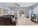 Living area with brown sectional sofa, access to back patio and stairs at 1017 Park Ridge Cir, Kissimmee, FL 34746