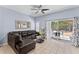 Living room with brown sectional sofa and sliding doors leading to a patio at 1017 Park Ridge Cir, Kissimmee, FL 34746