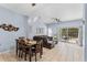 Light blue living room with tile floors, brown sectional sofa, and sliding glass doors to patio at 1017 Park Ridge Cir, Kissimmee, FL 34746