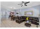 Living room with brown sectional sofa, access to kitchen and stairs at 1017 Park Ridge Cir, Kissimmee, FL 34746