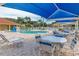 Community pool with tables, chairs, and shade umbrellas at 1017 Park Ridge Cir, Kissimmee, FL 34746
