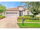 Luxury home with light colored walls and a brick driveway at 1395 Dolphin Head St, Davenport, FL 33896