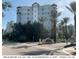 Modern high-rise building with palm trees and landscaping at 14501 Grove Resort Ave # 1505, Winter Garden, FL 34787