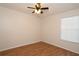 Neutral bedroom with a ceiling fan, mini blinds, and wood laminate flooring at 14764 Laguna Beach Cir, Orlando, FL 32824