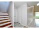 Hallway view with tile flooring and staircase access to the second story at 14764 Laguna Beach Cir, Orlando, FL 32824