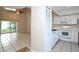 Kitchen with white appliances and view into living room at 14764 Laguna Beach Cir, Orlando, FL 32824