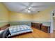 Well-lit bedroom with wood floors and dresser at 14962 Waterford Chase Pkwy, Orlando, FL 32828