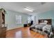 Bedroom with light-blue walls, wood floors, and a work area at 14962 Waterford Chase Pkwy, Orlando, FL 32828