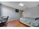 Bright bedroom with wood floors, neutral walls, and a workspace at 14962 Waterford Chase Pkwy, Orlando, FL 32828