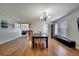 Bright dining room with hardwood floors and a view of the living room at 14962 Waterford Chase Pkwy, Orlando, FL 32828