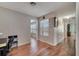 Light-filled hallway with wood floors and access to multiple rooms at 14962 Waterford Chase Pkwy, Orlando, FL 32828