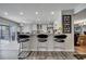 Modern kitchen with a breakfast bar and three black barstools at 14962 Waterford Chase Pkwy, Orlando, FL 32828
