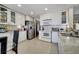 Modern kitchen with white cabinets, granite countertops, and stainless steel appliances at 14962 Waterford Chase Pkwy, Orlando, FL 32828