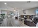 Spacious living room with leather sectional sofa and wood-look floors at 14962 Waterford Chase Pkwy, Orlando, FL 32828