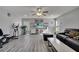 Open living room with grey flooring and a sectional sofa at 14962 Waterford Chase Pkwy, Orlando, FL 32828