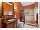 Elegant bathroom with dark wood vanity and large walk-in shower at 1515 Sunset Pointe Pl, Kissimmee, FL 34744