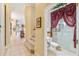 Small bathroom with shower, toilet, and decorative curtain at 1515 Sunset Pointe Pl, Kissimmee, FL 34744