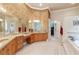 Large bathroom with double vanities, soaking tub, and separate shower at 1515 Sunset Pointe Pl, Kissimmee, FL 34744