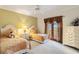 Charming bedroom with two twin beds and access to balcony at 1515 Sunset Pointe Pl, Kissimmee, FL 34744
