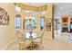 Bright breakfast nook with glass table and four chairs, overlooking a scenic view at 1515 Sunset Pointe Pl, Kissimmee, FL 34744