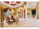 Formal dining room features a glass-top table, chandelier, and hardwood floors at 1515 Sunset Pointe Pl, Kissimmee, FL 34744