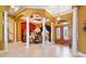 Grand entryway with high ceilings, elegant columns, and a view of the formal dining area at 1515 Sunset Pointe Pl, Kissimmee, FL 34744