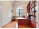 Bright home office features built-in shelving, hardwood floors, and a large window at 1515 Sunset Pointe Pl, Kissimmee, FL 34744