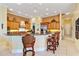 Gourmet kitchen boasts granite counters, custom cabinetry, and an island at 1515 Sunset Pointe Pl, Kissimmee, FL 34744