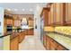 Bright kitchen with wood cabinets, granite countertops, and stainless steel appliances at 1515 Sunset Pointe Pl, Kissimmee, FL 34744