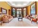Spacious living room with large windows, comfortable seating, and a view of the pool at 1515 Sunset Pointe Pl, Kissimmee, FL 34744
