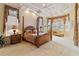 Luxurious main bedroom with a king-size bed, sitting area, and bay windows at 1515 Sunset Pointe Pl, Kissimmee, FL 34744