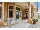 Covered patio with seating area and dining table, adjacent to the house at 1515 Sunset Pointe Pl, Kissimmee, FL 34744