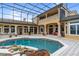 Large pool and patio with screened enclosure, adjacent to the house at 1515 Sunset Pointe Pl, Kissimmee, FL 34744