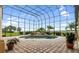 Screened pool and spa with fountain, surrounded by a brick patio at 1515 Sunset Pointe Pl, Kissimmee, FL 34744