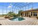 Octagonal pool with a waterfall feature and screened enclosure at 1515 Sunset Pointe Pl, Kissimmee, FL 34744