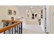 Upstairs hallway with hardwood flooring and wrought-iron railing at 1515 Sunset Pointe Pl, Kissimmee, FL 34744