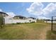 Large backyard with grassy area and white fence at 1606 Steely Dr, Dundee, FL 33838