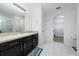 Bathroom with dark vanity, shower, and tile floor at 1606 Steely Dr, Dundee, FL 33838