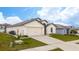 One-story house with a two-car garage and landscaped yard at 1606 Steely Dr, Dundee, FL 33838
