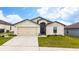 One-story home with attached garage and well-manicured lawn at 1606 Steely Dr, Dundee, FL 33838