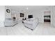 Living room with grey couch and view into bedroom at 1606 Steely Dr, Dundee, FL 33838