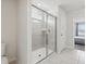 Bathroom featuring glass enclosed shower with bright neutral tile and a toilet at 1607 Kona Ln, Davenport, FL 33897