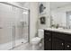 Modern bathroom featuring glass-enclosed shower and granite vanity at 1607 Kona Ln, Davenport, FL 33897