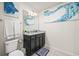 Well-lit bathroom featuring granite countertops, a decorative mirror, and stylish decor for a polished look at 1607 Kona Ln, Davenport, FL 33897