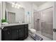 Clean bathroom with granite vanity, framed mirror, tiled shower, and modern fixtures at 1607 Kona Ln, Davenport, FL 33897