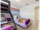 Bedroom with a bunk bed, a full size bed, and a striped accent wall at 1607 Kona Ln, Davenport, FL 33897