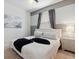 Bedroom featuring an upholstered headboard, soft lighting, and neutral color palette at 1607 Kona Ln, Davenport, FL 33897