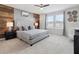Bedroom featuring a bed with a tufted headboard, a wood accent wall, and two windows at 1607 Kona Ln, Davenport, FL 33897